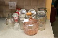 Overview of jars showing various glass jars in different sizes, including some with metal lids and a pink glass jar with lid.