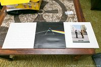 Three Pink Floyd vinyl albums on table: The Wall, Dark Side of the Moon, Wish You Were Here, showing full front covers.