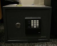 Front view of the Sentry safe showing the electronic keypad and key lock.