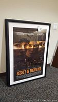Framed movie poster of 'Secret in Their Eyes' showing the four main actors and city skyline background