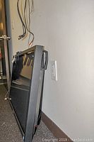 Side angle of Panasonic plasma display leaning against the wall showing thickness and side bezel.