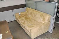 Front-side view of beige micro suede sofa placed in room environment