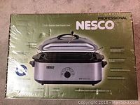 Photo showing the Nesco Professional 18 QT Stainless Steel Roaster Oven in original sealed packaging with the box front view visible.