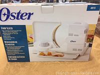 Original box of Oster Food Slicer model 4815, showing product image and branding.