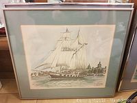 Framed picture of tall ship "Black Jack" near Kingston waterfront under museum or historical buildings.