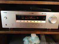 Front view of Yamaha Natural Sound AV Receiver HTR-5930 showing display, buttons, and volume knob.