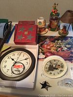 Overview of all items including wall clock, desktop clocks, candleholders, and box of napkin rings