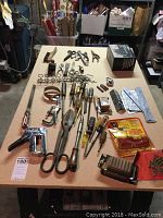 Photo of assorted hand tools laid out on a fiber board table