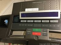Close-up of Preform XP 615 treadmill control panel with digital display and various control buttons including start, stop, speed, and incline.