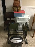 Overview of all items including file rack with folders, shredder underneath, chair, plastic bin, and baskets stacked.