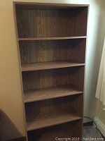 Front view of the 5 shelf laminate bookcase showing overall structure and shelf spacing.