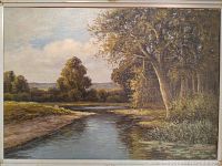 Full view of the framed oil painting of a landscape with a river, trees, and distant hills, signed Reitman in bottom left corner.