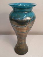 Front angle view of the vintage hand blown art glass vase showing the pewter and baby blue swirls and flared lip.