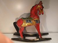 Full side view of the entire rocking horse showing body, rockers, and overall design