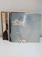 Front view of 5 stacked LP records showing John Lennon - Imagine album on top with faded cloud cover artwork.
