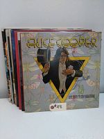 Photo showing a stack of vinyl LP records with Alice Cooper 'Welcome to My Nightmare' album at front