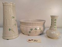 All three porcelain pieces grouped: tall vase, large bowl, small vase