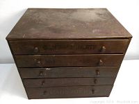 Front view of cabinet showing five drawers with embossed labels