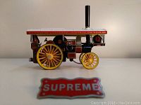 Side view of Fowler B6 Locomotive toy model with Supreme badge placed in front