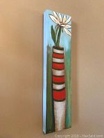 Full view of the vertical painting showing the white flower in striped vase.