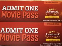 Two Landmark Cinema general admission movie passes, red-orange color, each admitting one person.