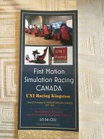 Photo of flyer depicting the UNI Racing Kingston setup, showing rows of racing motion simulator seats and monitors.