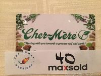 Photo of the $50 gift card from Cher-Mère Day Spa showing the logo and tagline with natural botanical design elements.