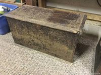 Closed antique rectangular wooden tool box showing worn wood surface and latch on lid