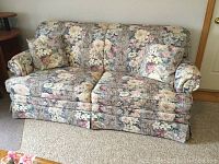 Sofa bed upholstery, cushions, and armrest details visible in the image.