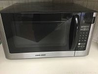 Black & Decker microwave with stainless steel front, black handle and digital keypad