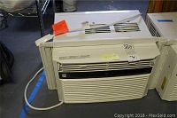 Image showing front and side view of the Kenmore window air conditioner unit with power cord and vent.