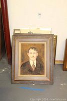Full view of the painting with wooden frame, showing the portrait of the man.