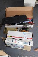 Boxed Norton IM200 Professional Sharpener System and other boxed kitchen tools including mandoline slicer visible.