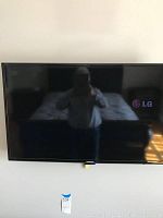 Front view of the Samsung 42 inch LED TV turned off showing reflection on screen and Samsung logo on lower bezel.