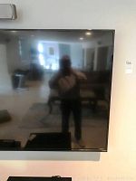 Front view of 70" Vizio TV, reflection shows room interior