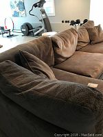 Sectional sofa in finished basement showing chaise on left and loveseat on right