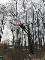 Full view of hoop assembly including backboard, rim, net and pole