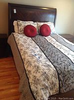Front view of assembled queen bed with linens and headboard