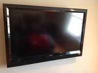Front view of the Vizio 40-inch flat screen television mounted or held upright, showing black frame and screen surface.