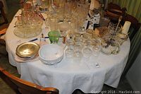 Overview of mixed glassware, serving containers, and bowls including pitcher and various small jars and bowls.