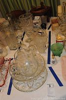 Full view of crystal glassware including tall vase, bowl, pitcher, tray, and various smaller glass items.