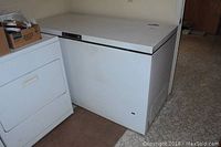 White Kenmore chest freezer next to another appliance