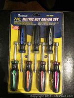 Photo showing 7-piece Pittsburgh metric nut driver set in original packaging with sizes and product details visible.