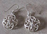 Front view of the sterling silver Celtic design pierced earrings on a neutral background showing the intricate openwork knot design and hook fastening.