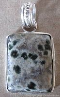 Front view of the rectangular ocean jasper stone pendant set in sterling silver with fancy bale.