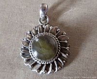 Front view of vintage sterling silver labradorite pendant showing twisted and beaded petal frame with stone.