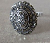 Close-up of oval marcasite ring top showing detailed stone setting and filigree silver work.