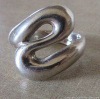 Close-up front view of a sterling silver modernist ring showing its smooth curved open loop design.