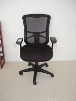 Front view of black office chair showing mesh backrest, cushioned seat, and armrests.