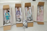 Four Gene porcelain dolls by Mel Odom inside open Ashton Drake Gallery boxes, accessories and DVD included